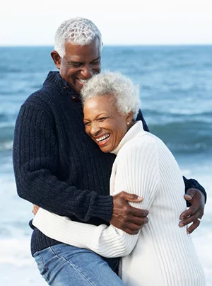 Senior Couple with denture implants hugging