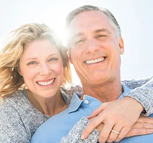 Smiling dental implants patient in Lone Tree Colorado with happy wife