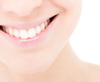 Smiling patient who received porcelain veneers from a dentist in Lone Tree.