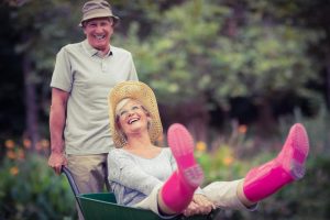 Laughing husband and wife in the garden found TMD relief with Botox in Denver