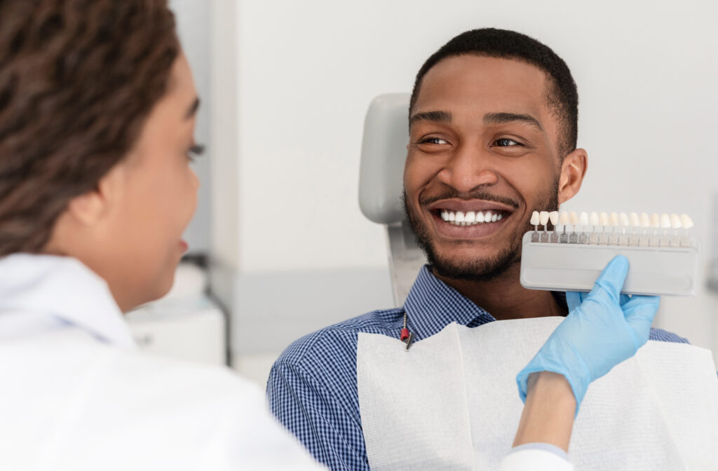 Male patient in Central Park reviewing dental veneers options at the dentist