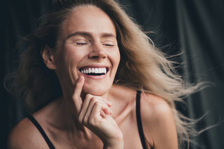 closeup of a woman smiling, natural new veneers
