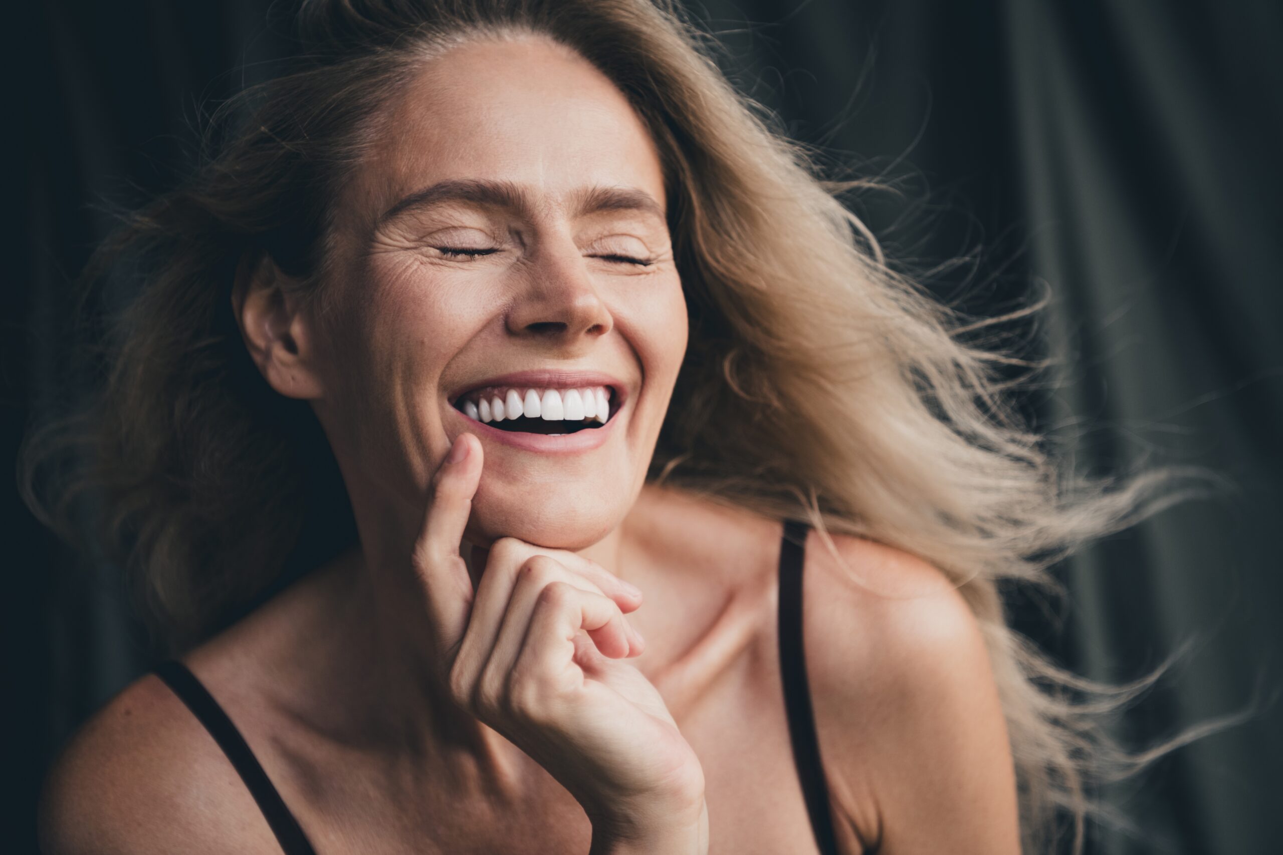closeup of a woman smiling, natural new veneers